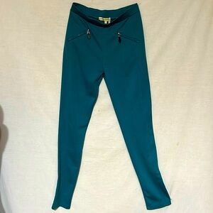 Teal color knit fabric slacks. Woman size M. Has decorative zippers on front.